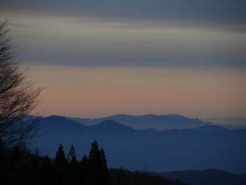 Scenic view of silhouette mountains against sky at sunset