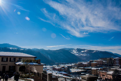 Houses in town against blue sky