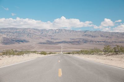 Road amidst landscape against sky