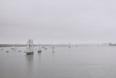 Boats sailing in sea against sky