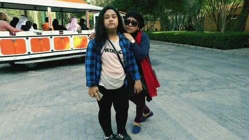 Young woman with arms raised