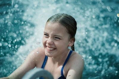 Portrait of smiling man swimming in pool