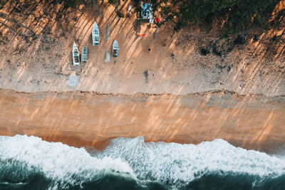 High angle view of people on rocks by sea