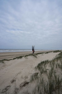 Handstand on a beach near the sea europe