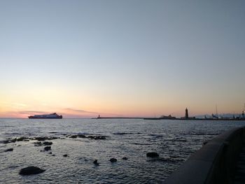 Scenic view of sea against clear sky during sunset