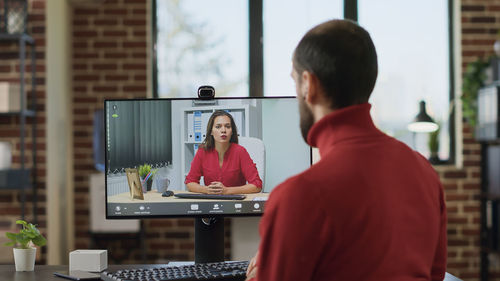 Businessman having video call on desktop pc at office