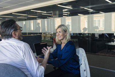 Two professionals discussing in office