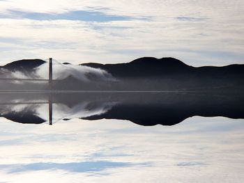 Scenic view of mountains against cloudy sky