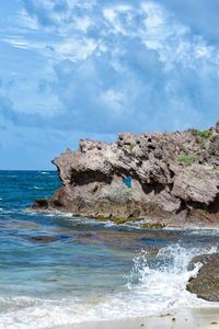 Rocks on beach against sky