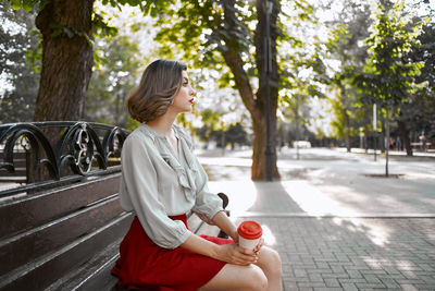 Full length of woman sitting in park