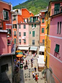 High angle view of people on street amidst buildings in city