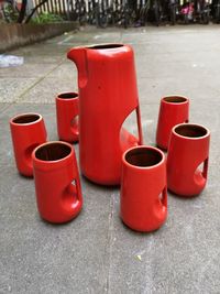 Close-up of red wine glasses on sidewalk