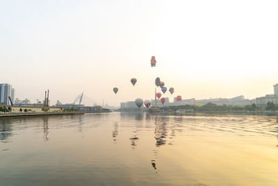 View of people on lake against clear sky