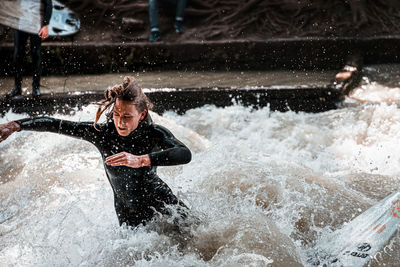 Full length of man splashing water