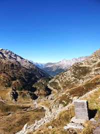 Scenic view of mountains against clear blue sky