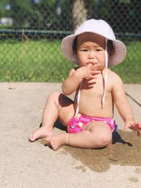 Full length of cute baby girl sitting in park