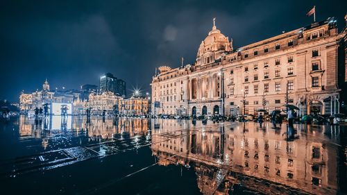 Reflection of buildings in city at night