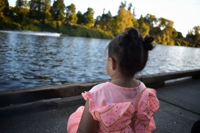 Rear view of woman looking at lake