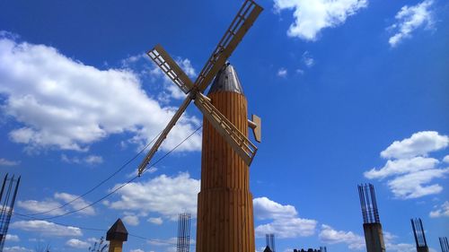 Low angle view of windmill against blue sky