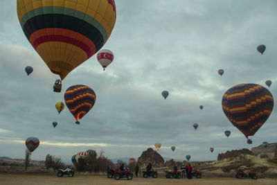 Low angle view of hot air balloons flying in sky