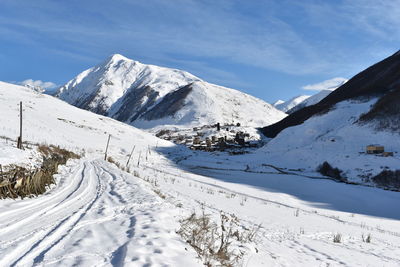 Scenic view of snow covered mountains against sky