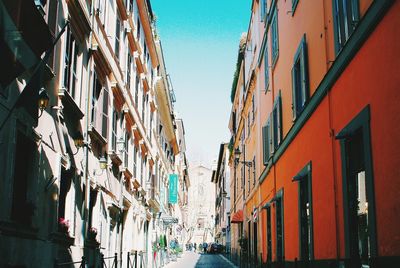 Road leading towards buildings in city