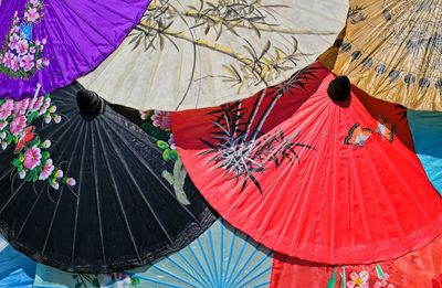 Low angle view of multi colored umbrellas hanging on clothesline