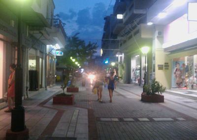 Illuminated city street at night