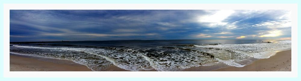 Scenic view of sea against cloudy sky