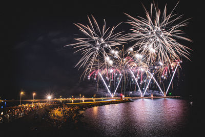 Low angle view of firework display at night