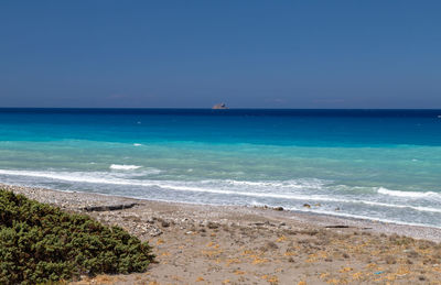 Scenic view of sea against clear blue sky