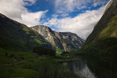 Scenic view of lake and mountains against sky