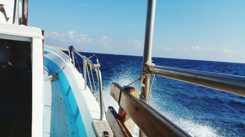 Boats in sea against blue sky