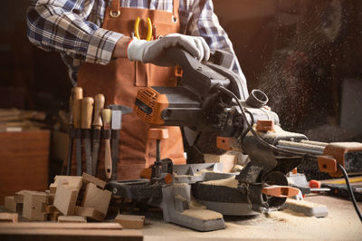 Midsection of man working at workshop