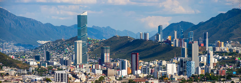 Panoramic view of buildings in city against sky