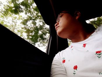Portrait of woman looking through car window