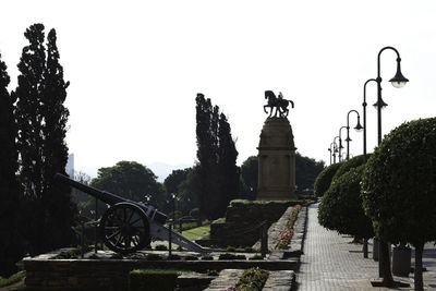 Statue in park against clear sky