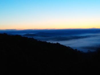 Scenic view of silhouette mountains against sky at sunset