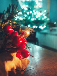 Close-up of illuminated christmas tree on floor at home