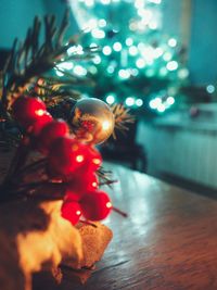 Close-up of illuminated christmas tree on floor at home