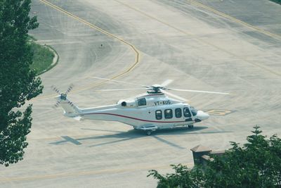 High angle view of airplane flying over road