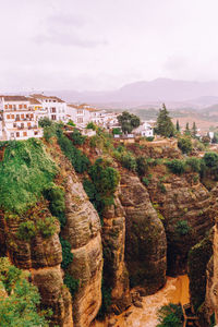 View of rocks and buildings against sky