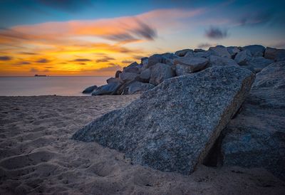 Scenic view of beach against sky during sunset