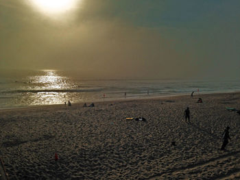 Scenic view of beach against sky during sunset