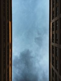 Directly below view of buildings against sky at dusk