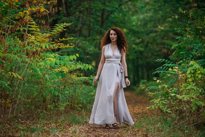 Woman standing in a forest