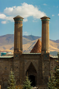 Double minaret madrasa.background palandoken mountain. erzurum, turkey