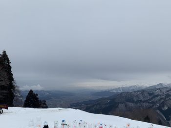 Scenic view of snow covered mountains against sky