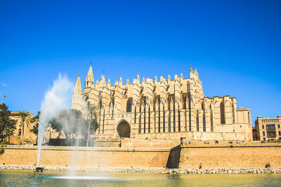 Panoramic shot of buildings against clear blue sky