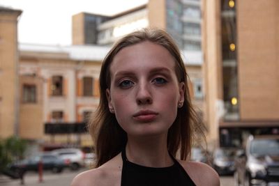 Portrait of young woman in city